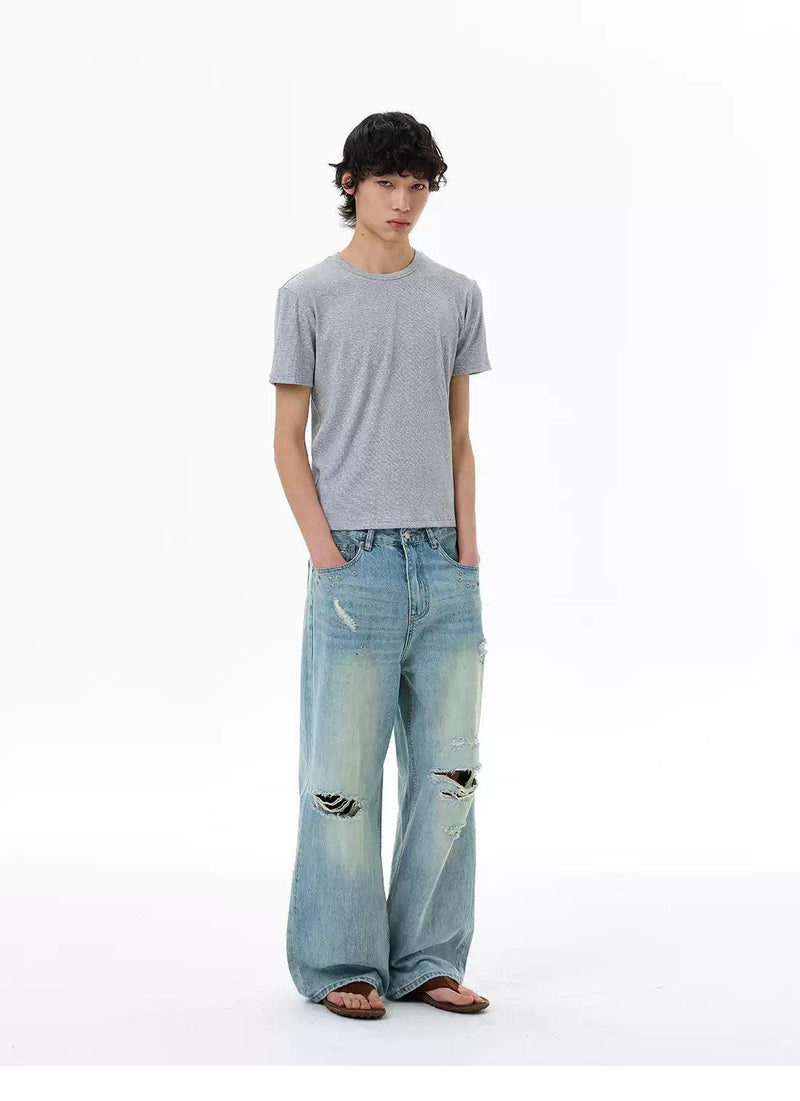 Ripped and Distressed Faded Jeans